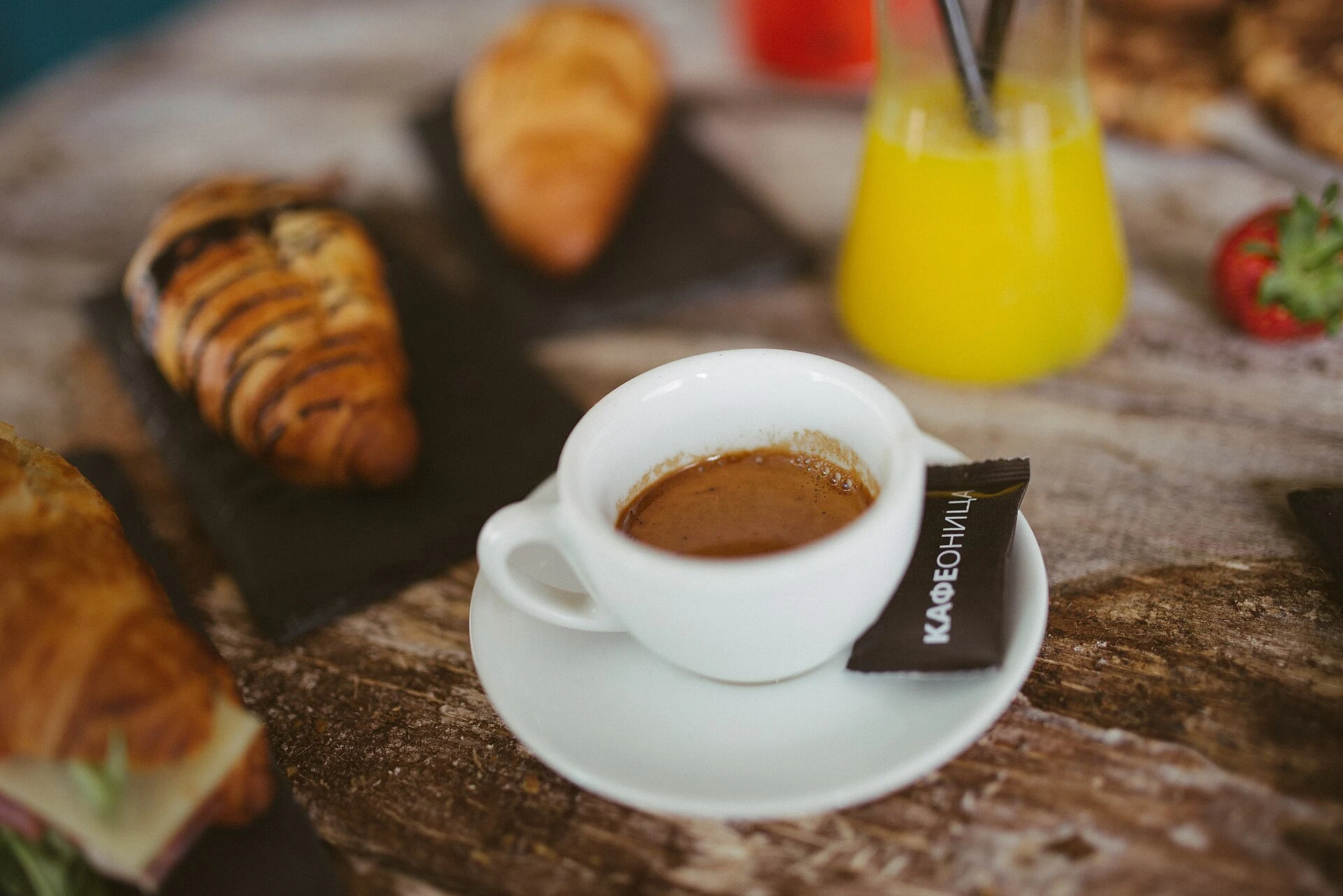 Espresso and pastries arranged on a warm café table